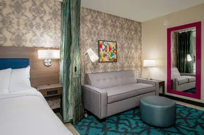 a hotel room with a bed and a couch at Home2 Suites By Hilton Grove City Columbus in Grove City