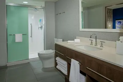 a bathroom with a sink and a toilet and a shower at Home2 Suites By Hilton Grove City Columbus in Grove City