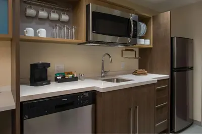 a kitchen with a sink and a microwave at Home2 Suites By Hilton Grove City Columbus in Grove City