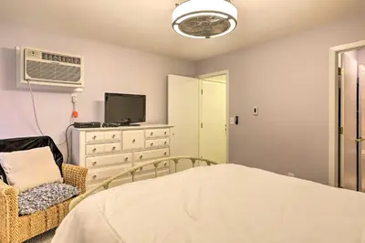 a bedroom with a bed and a tv and a chair at The Shores Condo with Beach Access Less Than 2 Mi to Dtwn! in Port Clinton