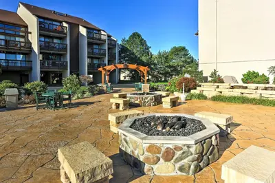 a courtyard with a fire pit in front of a building at The Shores Condo with Beach Access Less Than 2 Mi to Dtwn! in Port Clinton