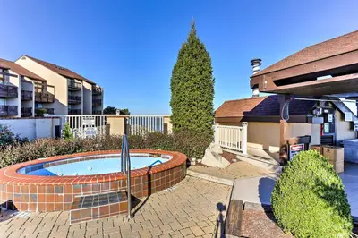 a small swimming pool in a yard next to a house at The Shores Condo with Beach Access Less Than 2 Mi to Dtwn! in Port Clinton
