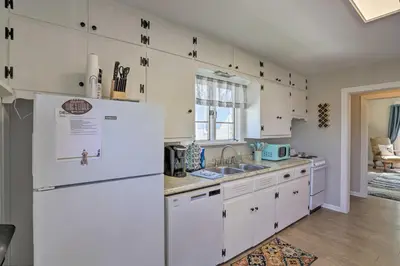 a kitchen with white cabinets and a white refrigerator at Port Clinton Getaway - Walk to Beach and Restaurants in Port Clinton