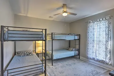 a bedroom with two bunk beds and a ceiling fan at Port Clinton Getaway - Walk to Beach and Restaurants in Port Clinton