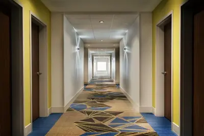 a hallway of a hotel with a carpeted corridor at Holiday Inn Express & Suites Heath - Newark by IHG in Heath