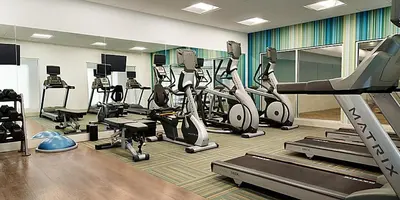 a gym with several treadmills and cardio machines at Holiday Inn Express & Suites Heath - Newark by IHG in Heath