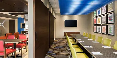 a conference room with tables and chairs and a tv at Holiday Inn Express & Suites Heath - Newark by IHG in Heath