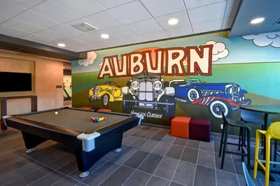 a pool table in a room with a mural at Tru By Hilton Auburn, In in Auburn