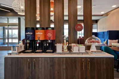 a counter with bottles of wine on top of it at Tru By Hilton Auburn, In in Auburn