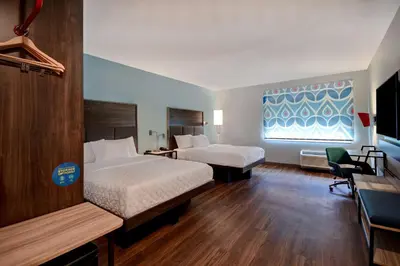 a hotel room with two beds and a window at Tru By Hilton Auburn, In in Auburn