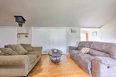 a living room with a couch and a table at Loft Unplugged with Outdoor Space in Amish Country! in Burton