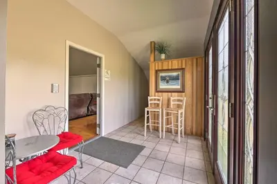 a living room with a table and chairs and a kitchen at Loft Unplugged with Outdoor Space in Amish Country! in Burton