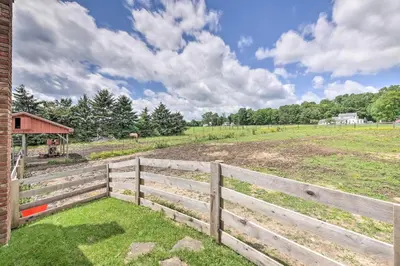 a wooden fence in front of a field at Loft Unplugged with Outdoor Space in Amish Country! in Burton