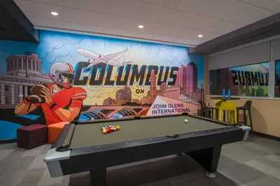 a pool table in a room with a mural at Tru By Hilton Columbus Airport in Columbus