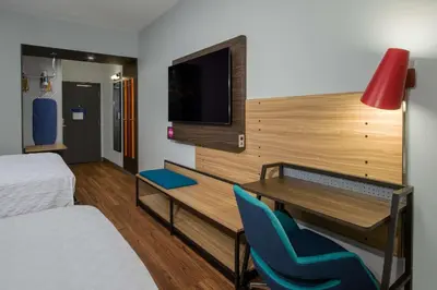 a room with a desk and a bed and a tv at Tru By Hilton Columbus Airport in Columbus