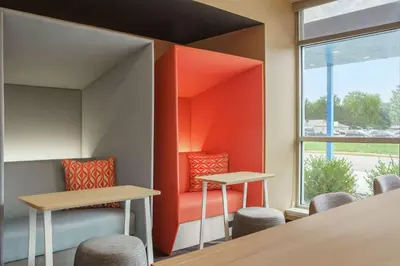 a room with two tables and chairs and a window at Tru By Hilton Sandusky, Oh in Sandusky