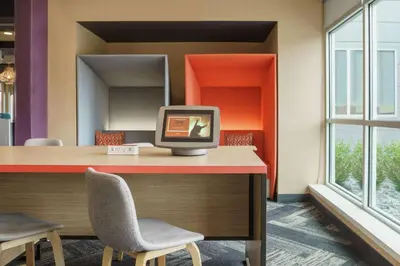 an office with a tv sitting on a desk with two chairs at Tru By Hilton Sandusky, Oh in Sandusky
