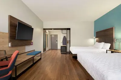 a hotel room with two beds and a desk and a tv at Tru By Hilton Sandusky, Oh in Sandusky