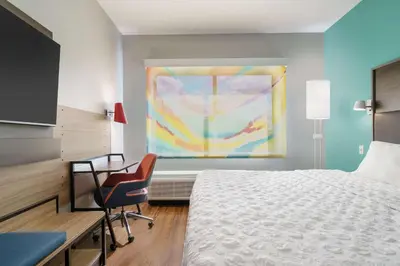 a bedroom with a bed and a desk and a window at Tru By Hilton Sandusky, Oh in Sandusky