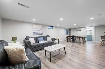 a living room with a couch and a table at Fishing & Skate Park, 10 mins to Ark, Sleeps 14 in Dry Ridge