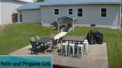 a patio and propane grill in front of a house at Fishing & Skate Park, 10 mins to Ark, Sleeps 14 in Dry Ridge