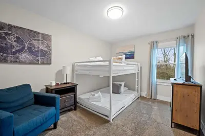 a living room with a bunk bed and a couch at Fishing & Skate Park, 10 mins to Ark, Sleeps 14 in Dry Ridge