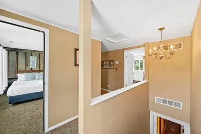 a bedroom with a mirror and a bed in a room at Country Lodge for 18, With Pool and Pond, Near Ark in Williamstown