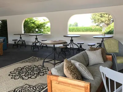a living room with two windows and a couch and tables at Millsite Lodge in Sandusky
