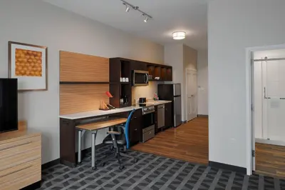 a kitchen with a desk and a counter top at TownePlace Suites Columbus Hilliard in Hilliard