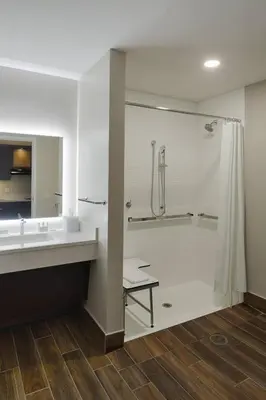 a bathroom with a shower and a sink at TownePlace Suites Columbus Hilliard in Hilliard