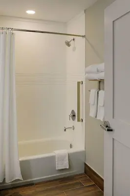 a bathroom with a bath tub with a shower curtain at TownePlace Suites Columbus Hilliard in Hilliard