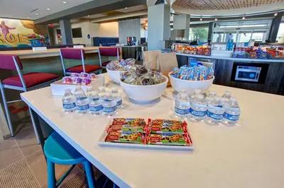 a table with bottles of water and snacks on it at Tru By Hilton Monroe, Oh in Monroe
