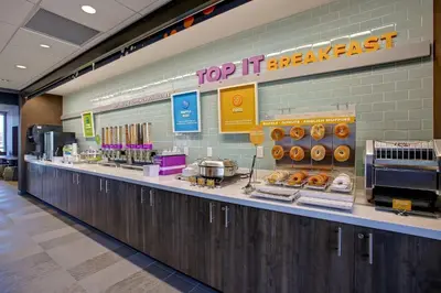 a bakery counter with donuts on top of it at Tru By Hilton Monroe, Oh in Monroe