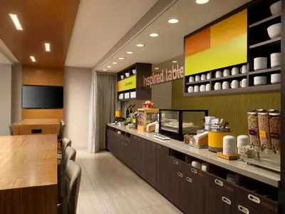 a fast food restaurant with a counter and a table at Home2 Suites Troy, OH in Troy