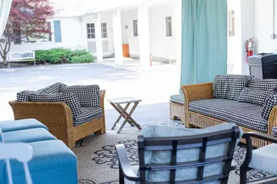 a patio with couches and chairs and a table at Homestead at Millsite Lodge in Sandusky