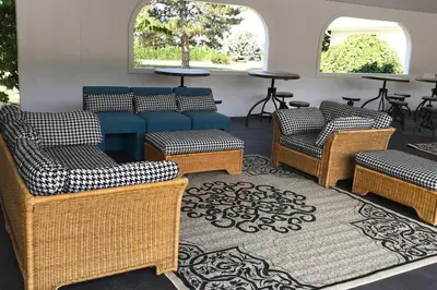 a waiting room with chairs and tables and windows at Homestead at Millsite Lodge in Sandusky