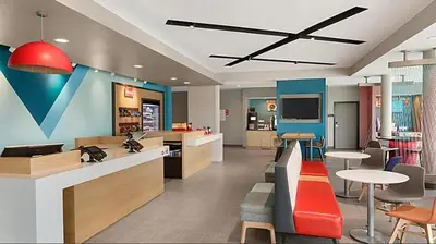 a lobby with a cafeteria with tables and chairs at avid hotels - Columbus Northwest - Hilliard by IHG in Hilliard