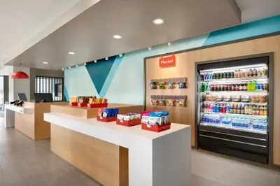 a store with a drink counter and a refrigerator at avid hotels - Columbus Northwest - Hilliard by IHG in Hilliard