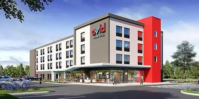 a rendering of a building with a car parked outside at avid hotels - Columbus Northwest - Hilliard by IHG in Hilliard