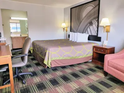 a hotel room with a bed and a desk at Sprucewood Inn in Elyria