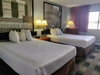 a hotel room with two beds and a window at Sprucewood Inn in Elyria