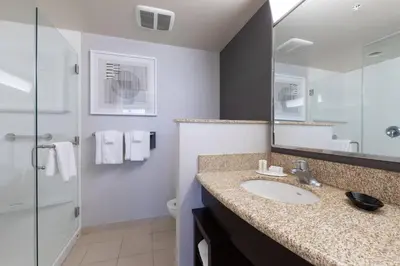 a bathroom with a sink and a mirror at Courtyard by Marriott Cincinnati Midtown/Rookwood in Cincinnati