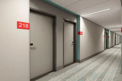 an empty hallway of an office building with doorsopens at Avid Hotels - Cincinnati N - West Chester by IHG in West Chester