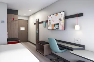 a hospital room with a bed and a chair at Avid Hotels - Cincinnati N - West Chester by IHG in West Chester