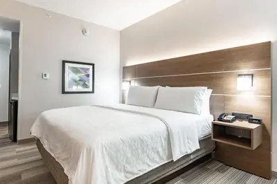 a hotel room with a large bed and a telephone at Holiday Inn Express & Suites - Moundsville by IHG in Moundsville