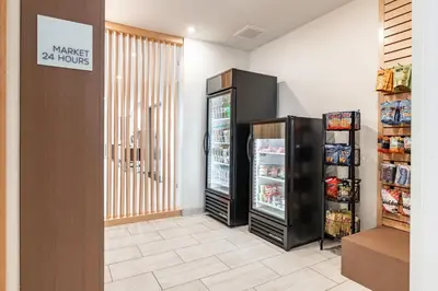 a store entrance with a refrigerator in a store at Holiday Inn Express & Suites - Moundsville by IHG in Moundsville