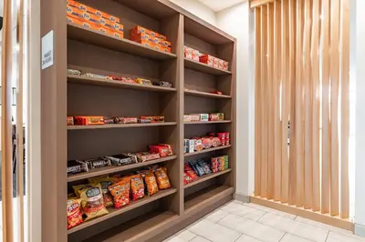 a walk in pantry with shelves filled with food at Holiday Inn Express & Suites - Moundsville by IHG in Moundsville