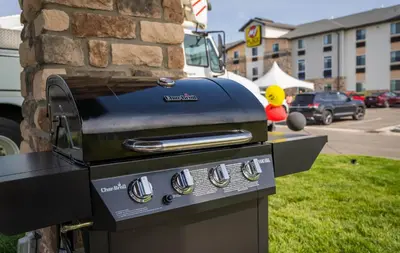 a grill sitting next to a brick building at My Place Hotel-Marion, OH in Marion