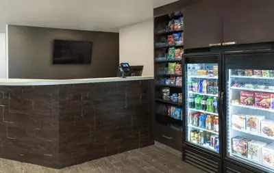 a drink station in a store with a refrigerator at My Place Hotel-Marion, OH in Marion