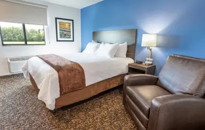 a hotel room with a bed and a chair at My Place Hotel-Marion, OH in Marion